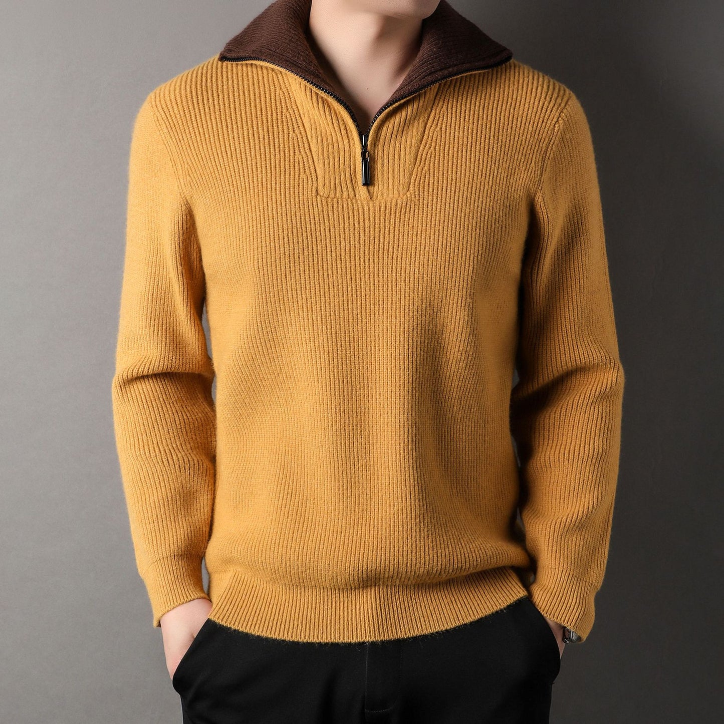 Yellow sweater with brown collar on a gray background