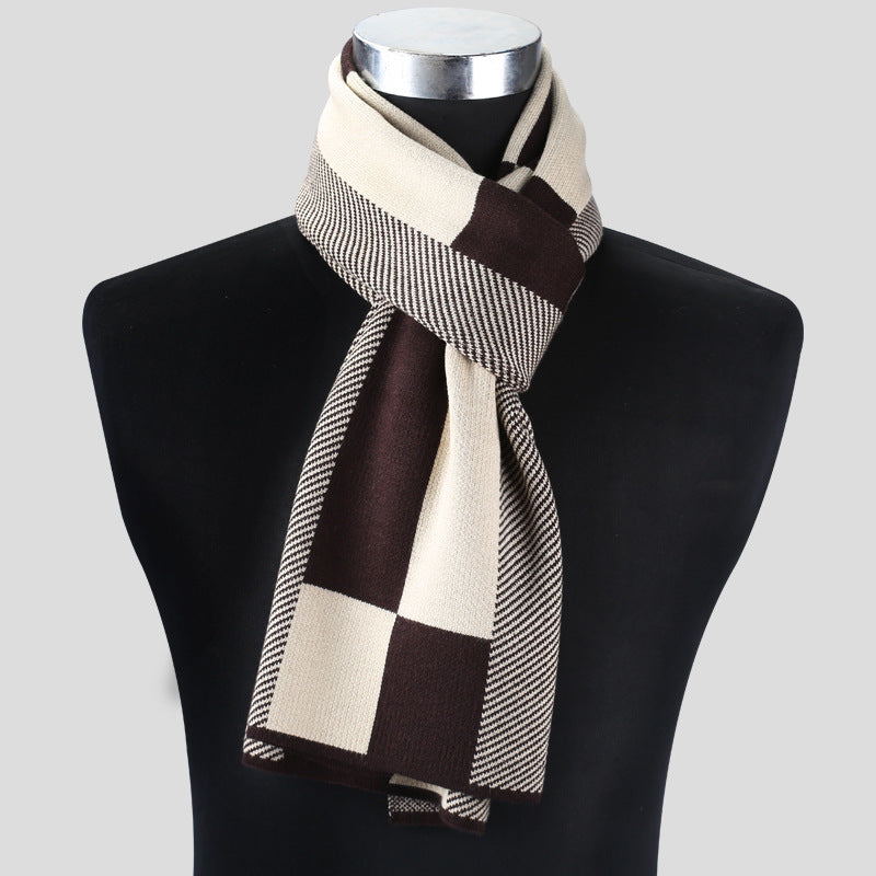 Plaid scarf in brown, beige, and black on a mannequin against a gray background