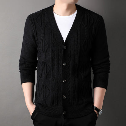 Black knitted cardigan worn by a person on a gray background