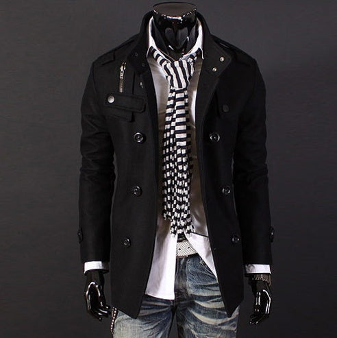 Mannequin wearing a black coat, white shirt, blue jeans, and a striped scarf on a dark background