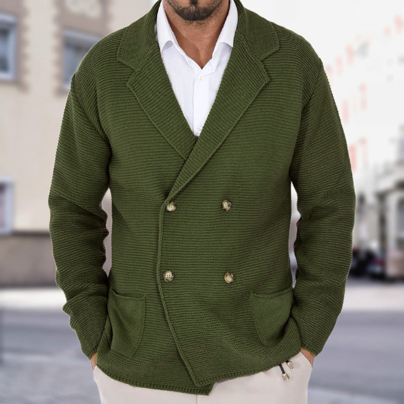 Green knitted blazer worn by a person with a blurred city street background