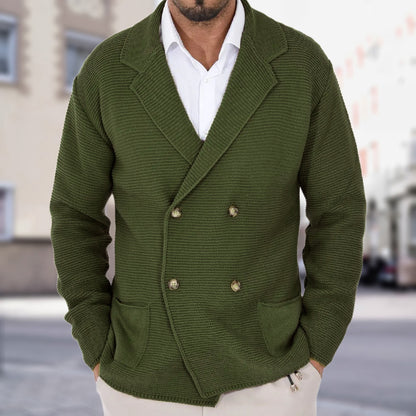 Green knitted blazer worn by a person with a blurred city street background