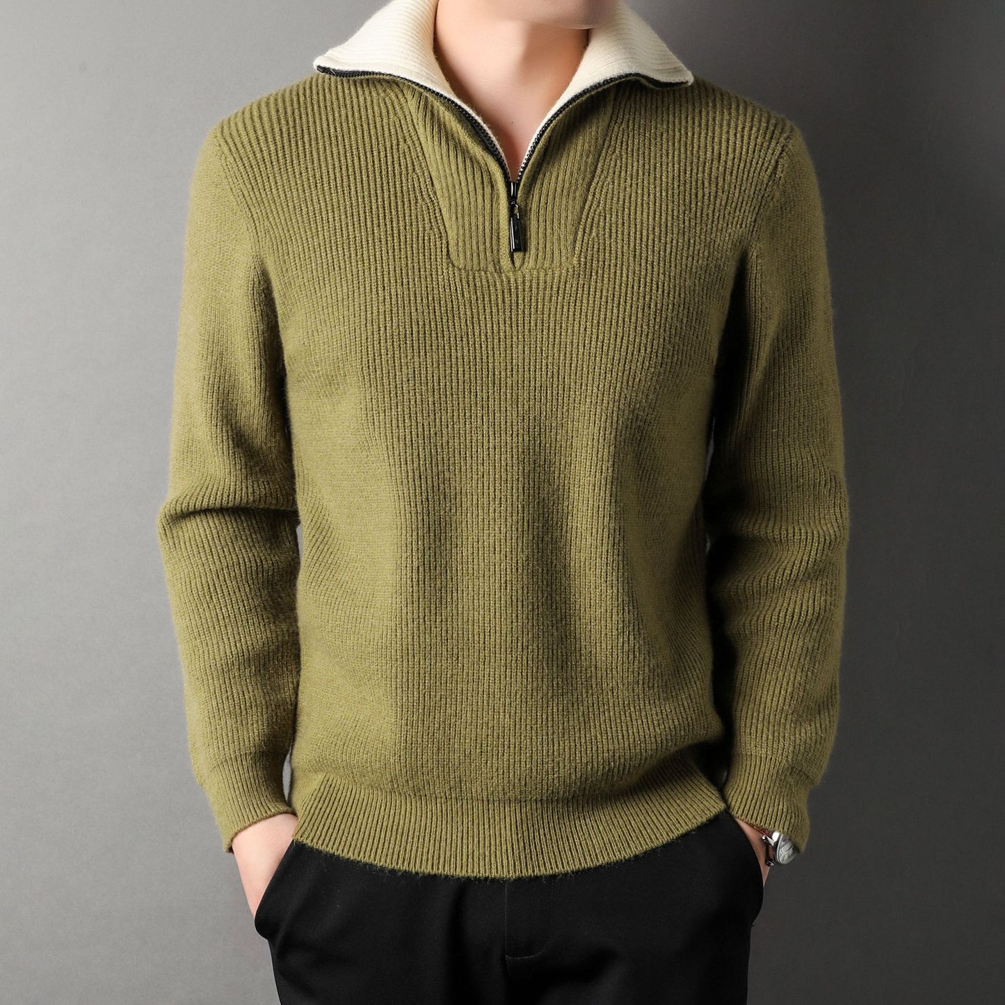 Green sweater worn by a person on a gray background