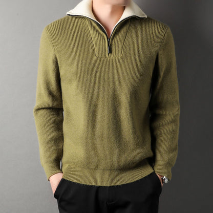 Green sweater worn by a person on a gray background