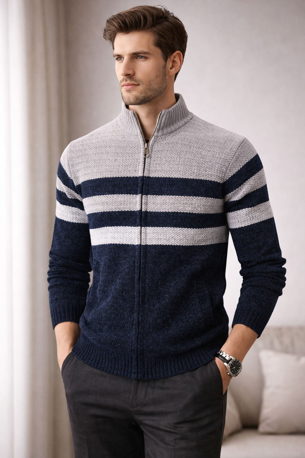 Man wearing a striped sweater with a neutral background