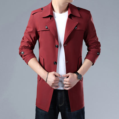 Red trench coat worn by a person on a gray background