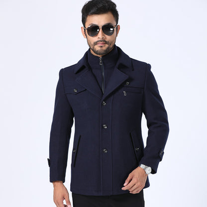 Man wearing a navy blue coat on a white background