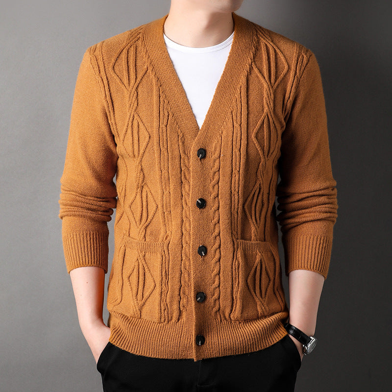 Brown cable knit cardigan worn by a person on a gray background