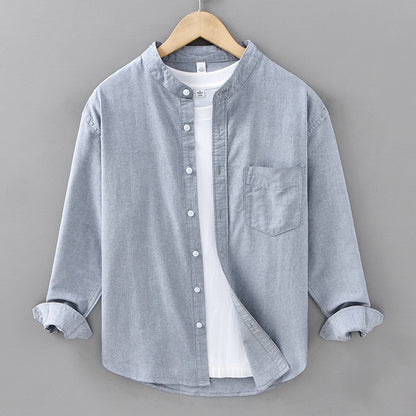 Gray button-up shirt on a hanger against a gray background