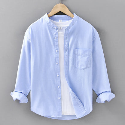 Light blue button-up shirt on a hanger against a gray background