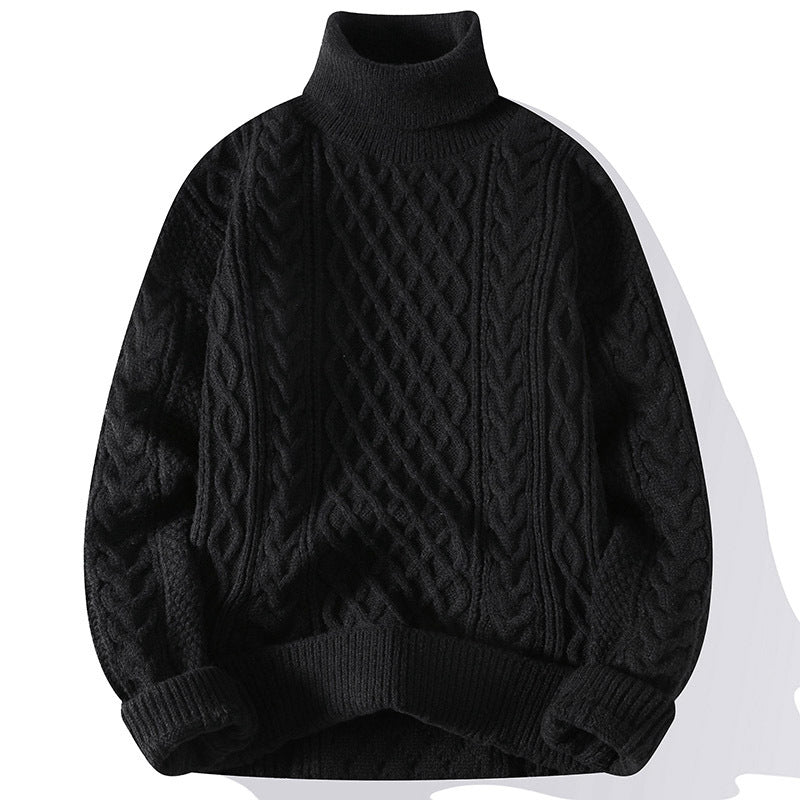 Black cable knit sweater on a white background