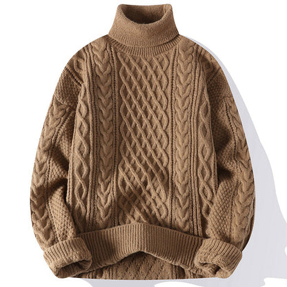 Brown cable knit sweater on a white background
