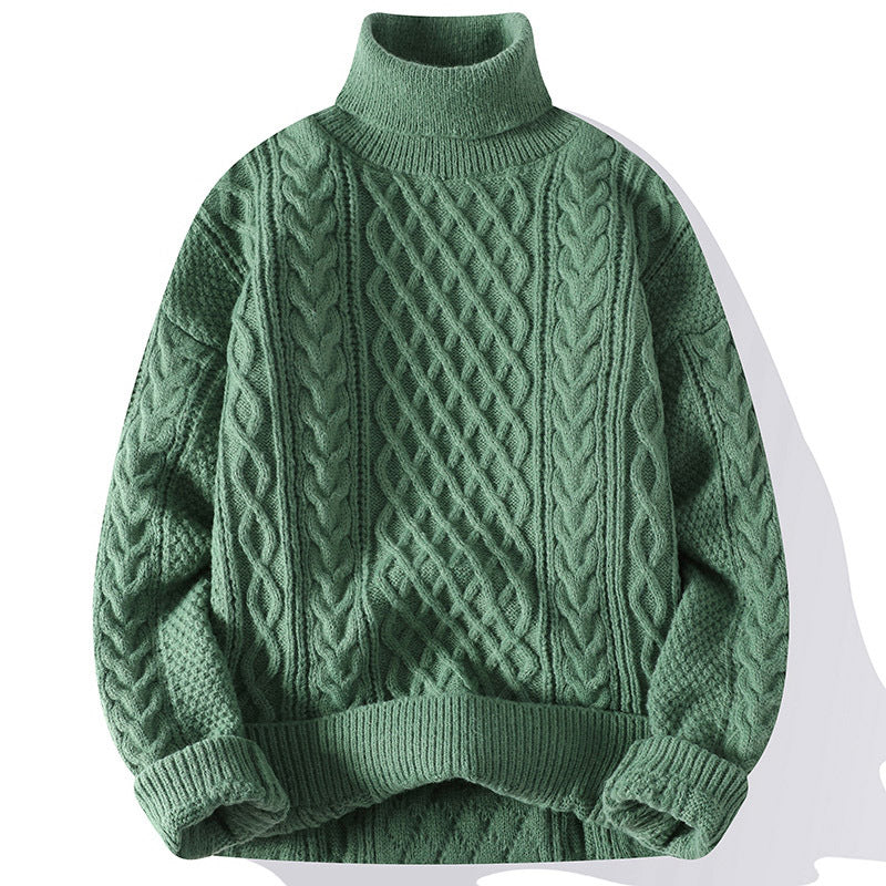 Green cable knit sweater on a white background