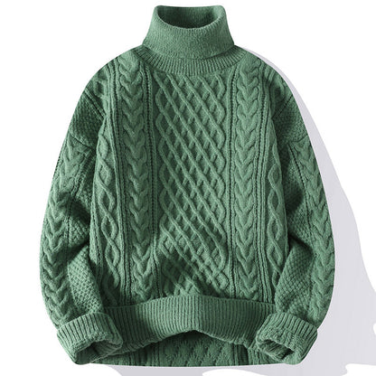 Green cable knit sweater on a white background